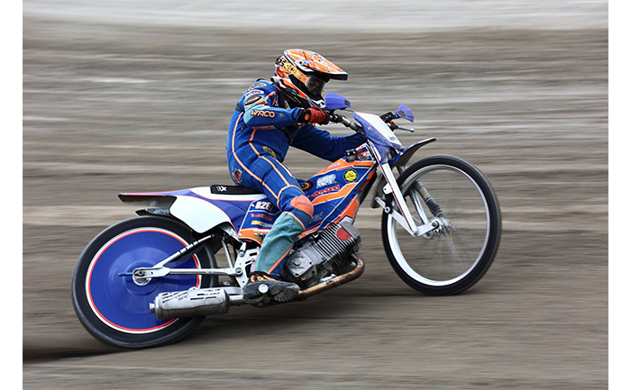 sample image of someone on a blue and orange motorbike taken on the canon r6 camera