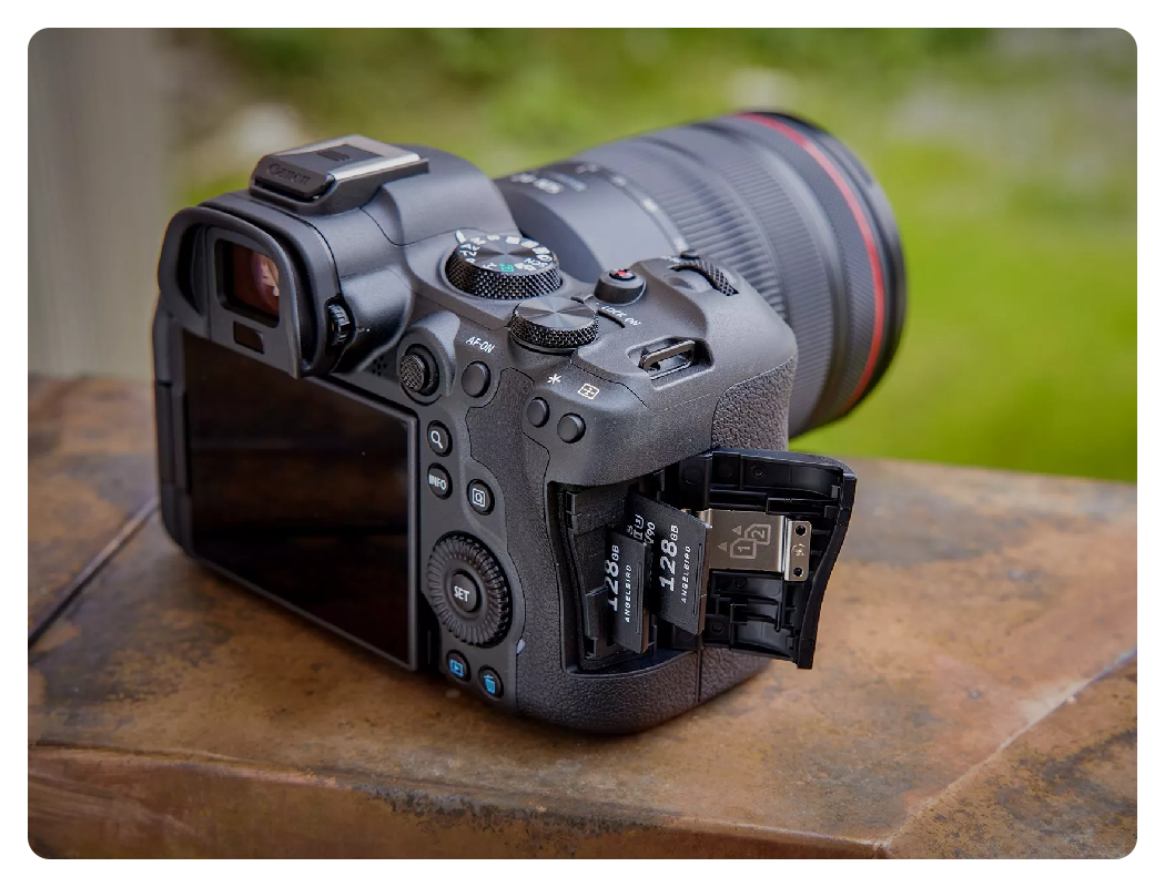 angled side view of the canon r6 mark ii showing the card slots on a brick wall