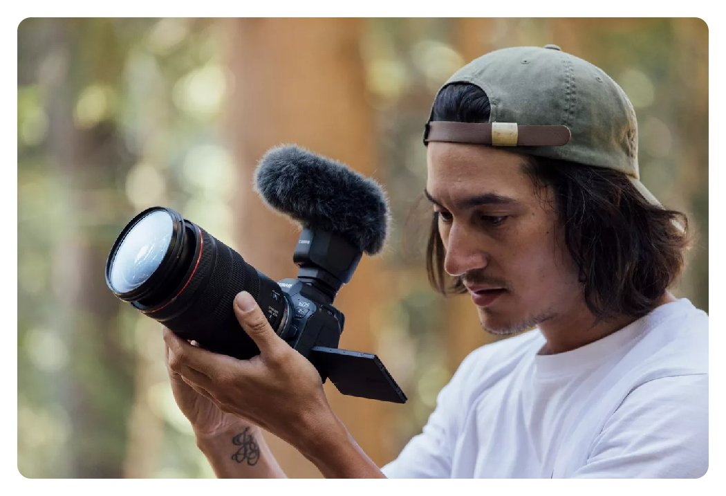 someone using the canon r6 mark ii camera with the viewfinder pulled out