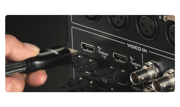 Person plugging hdmi cable into video inputs on Datavideo SE-4000