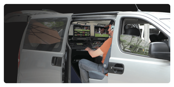 operator using Datavideo SE-4000 in the back of a small broadcast control van