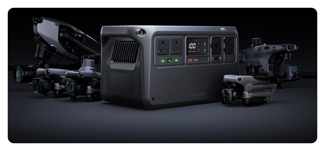 DJI portable power station with compatible drones next to it on a gray background