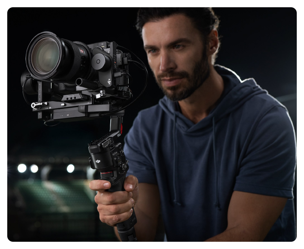 a man using the dji rs 4 during in filming