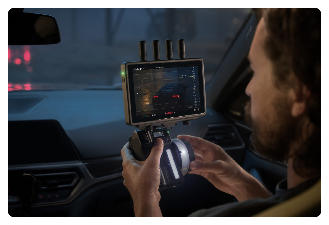 someone making adjustments using the DJI RS 4 Pro on set