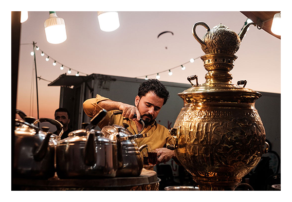 sample image of a man pouring tea taken with the fujifilm 35mm 1.4 lens