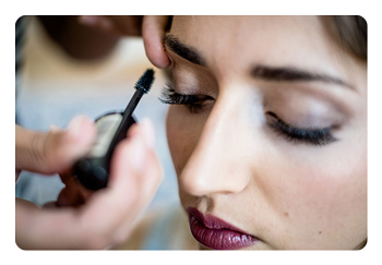 sample photo of someone applying makeup to a woman taken with the fujifilm 35mm 1.4 lens
