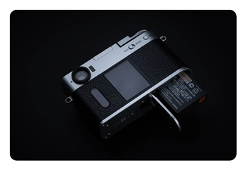 Fujifilm X half battery being inserted