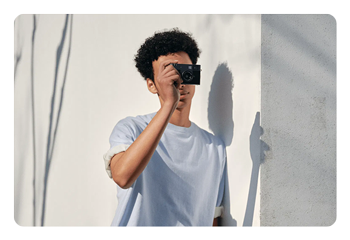 someone taking a photo using the Fujifilm X half