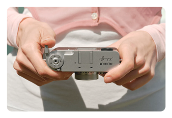 someone looking at the Fujifilm X half lcd viewfinder