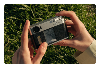 someone looking at the Fujifilm X half lcd screen