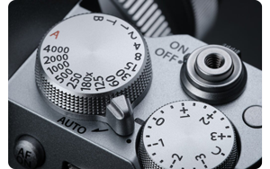 close up photograph of X-T50 control dials set to auto