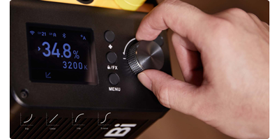 close up of person using the control wheel on Godox M600Bi
