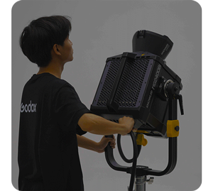 photograph of person adjusting godox mg2400bi on 360 degree yoke