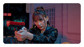 a woman on set holding a gun using the godox light effects