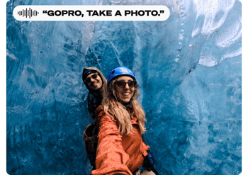 two female ice climbers standing infront of frozen ice wall