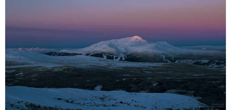 Hasselblad 907X 100C sample image landscape of frozen tundra lanscape with snow covered mountain with sunset pink sky