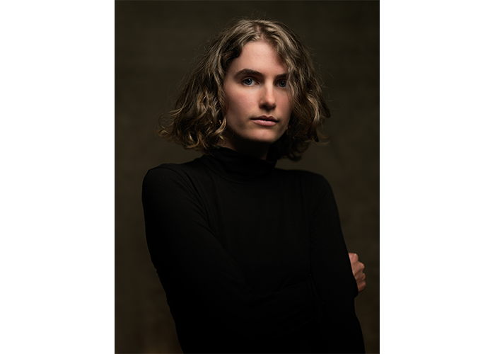 Hasselblad X2D 100C Lightweight Field Kit Sample Image portrait of a woman with shoulder length hair infront of deep brown backdrop