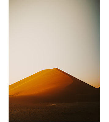 Hasselblad XCD35-75mm F3.5-4.5 Zoom Lens Sample Image Large Sand dun lit with strong orang sunlight against a clear sky