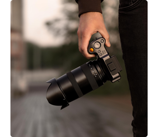Photographer holding Hasselblad X2D Medium format camera with XCD 35-75 lens