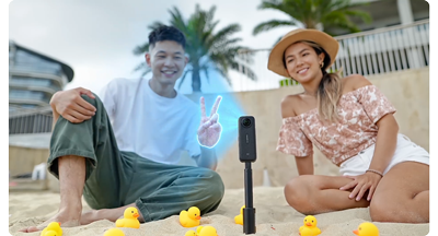 two people sat on beach with insta360 x4 camera