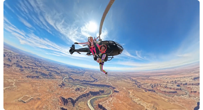 two sky divers jumping out of helicopter above grand canyon