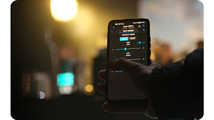 A smartphone being used on a video production or photography set to control lighting using the NANLINK app