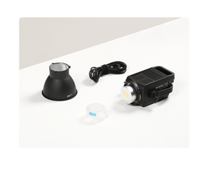 Nanlite FS200b sat on white table with lens cover, reflector and power cable