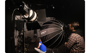Dark photography studio being lit by nanlite fs150b and fs200b with softboxes