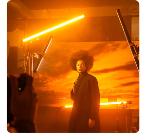 Female model standing in photography studio lit by PavoTube LED Lights