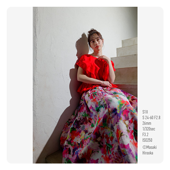 sample image of a woman sat on a staircase taken with the Panasonic LUMIX S1II