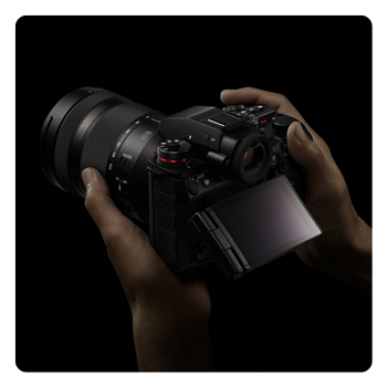 someone holding the Panasonic LUMIX S1II with the screen tilted out