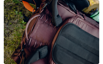 Close up photograph of Peak Design outdoor backpacks adjustable strap fitment range on eclipse colour bag laying on moss