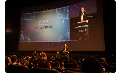 large exhibition screen at a theatre speaking event