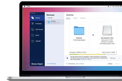 Apple macbook laptop with Acronis True Image Backup software window open