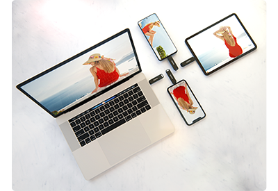 apple macbook with iphone, ipad pro and android phone with sandisk ixpand flashdrive luxe connected to each transfering data