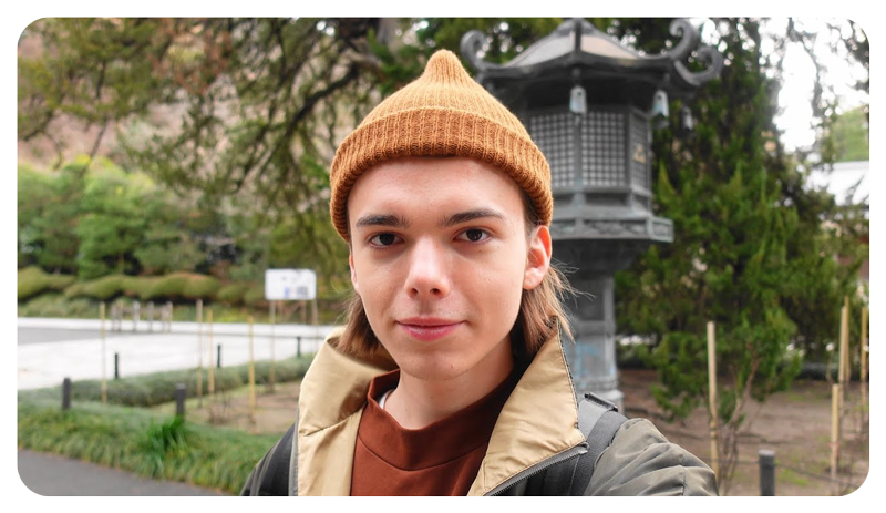 Sony ZV-1 Vlog Camera sample photo of young man wearing an orange beanie standing infront of a traditional japanese lantern
