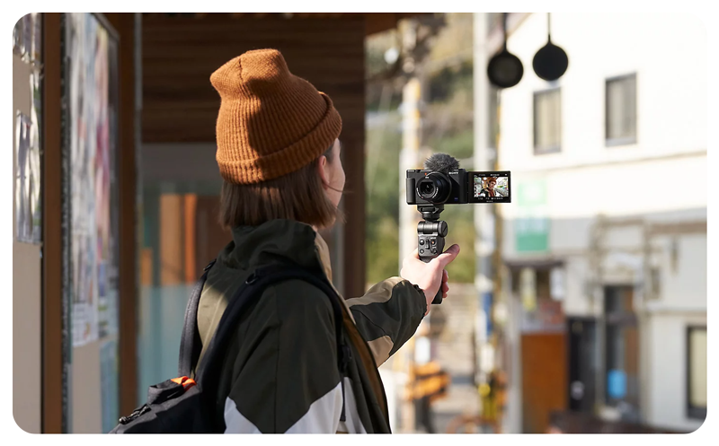 Photo of man wearing orange beanie vlogging using Sony ZV-1 Camera