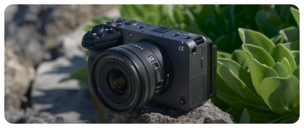 Sony FX30 Compact Cinema Line Camera sat on stone wall infront of green leaves