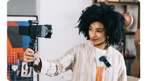 a woman using zv-e10 with control grip to vlog