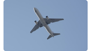 a photo of a plane flying above across a blue sky