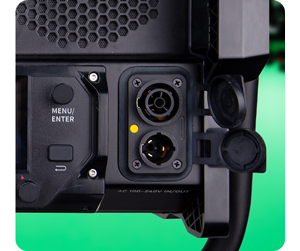 close up image of LED panel light power connections in front of green screen