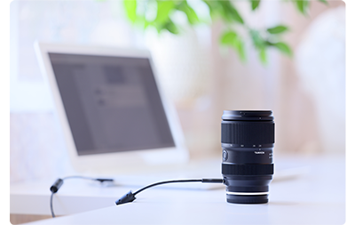 Tamron lens being updated using USB and a laptop with Lens Utility, Tamron 70-180mm F2.8 Di III VC VXD G2 Lens E Mount