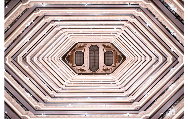 TTArtisan 10mm F2 ASPH sample photograph of tall builing foyer looking directly up at the angular ceiling showing each level of the building
