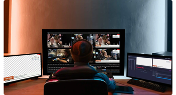 image of producer editing broadcast graphics with Vizrt Flowics on 3 monitor setup