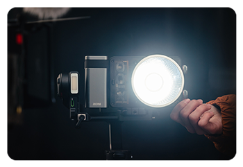 someone adjusting the brightness of the zhiyun light in a studio