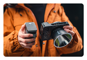 someone attaching the battery grip to the zhiyun light