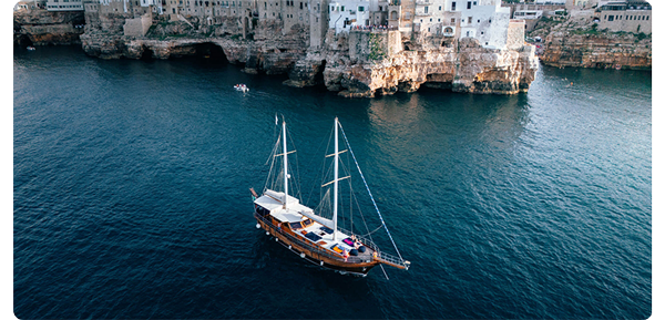 sample images from dji mini 4 pro, sail boat in clear blue harbour water