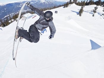 Skiier performing grab trick mid air