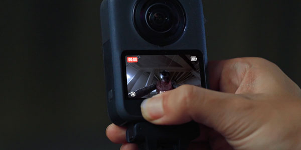 person starting snapshot recording on dji osmo 360