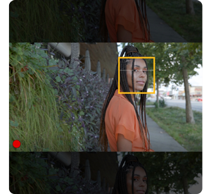 video still of a woman stood infront of a garden edge with autofocus bracket surrounding her face, lumix s pro 16-35mm